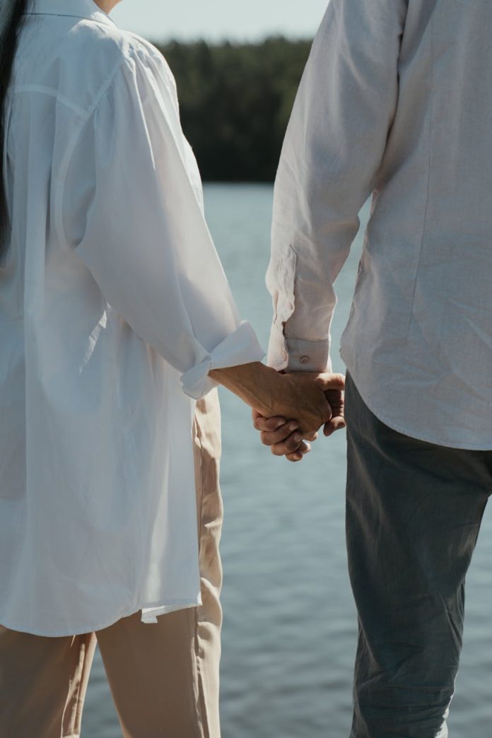 an elderly couple holding hands